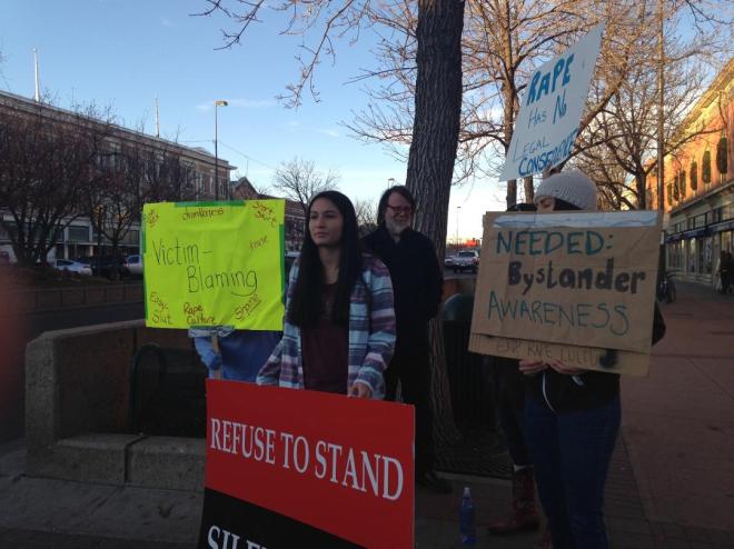 Protestors stand at the intersection of Mountain and College Ave. in Old Town Ft. Collins to fight against Rape Culture. Photograph taken by Megan Fischer
